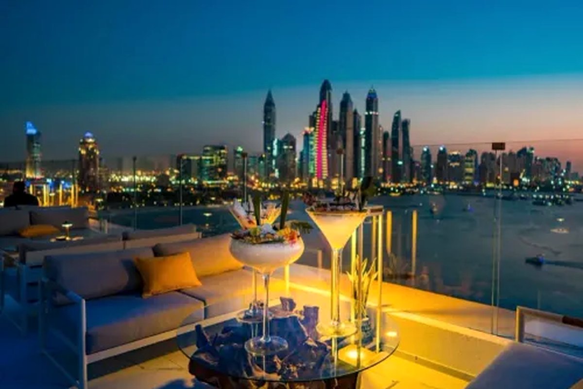 An elegant dinner setting against the Dubai skyline at dusk