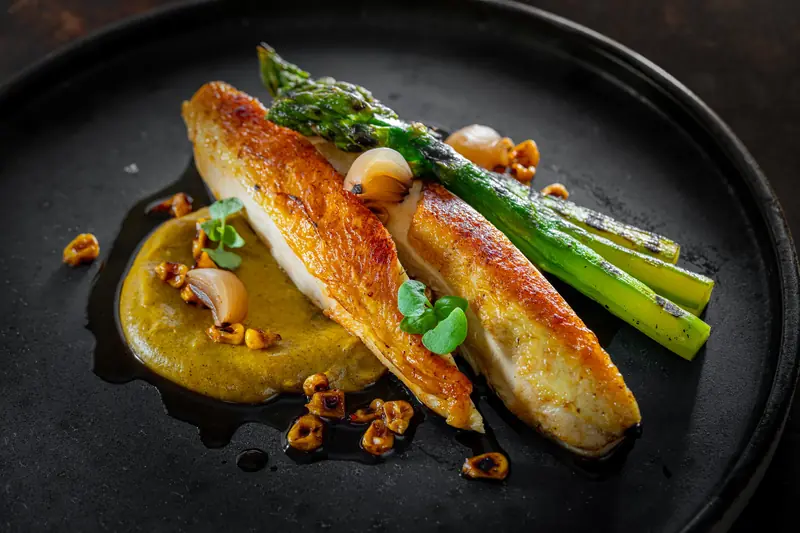 Roast chicken breast with grilled asparagus, a golden purée and toasted nuts by myCHEF Cape Town