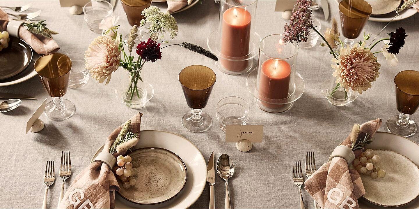 Private dining table detail in a Cape Town villa — linen, cutlery and handwritten place cards